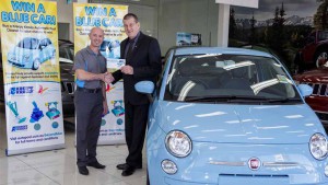 Lucky winner Alan McDougall receiving the keys to a new Blue Fiat from beyondblue chairman Jeff Kennett