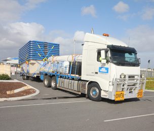 Ten multi-stacked fibreglass pools leaving the Jandakot premises of Aqua Technics Commercial on their 1380km trip to Onslow