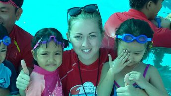 Emily McNeill helping kids learn to swim in Vietnam