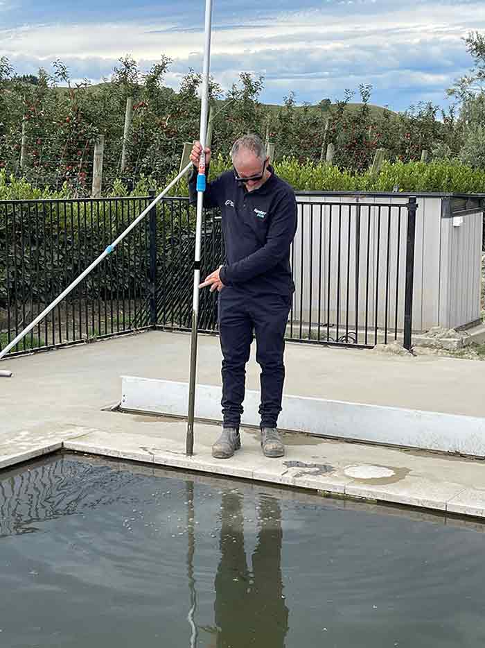 Mike from Narellan Pools measuring the silt/mud in the bottom of the pool, nearly a metre in this pool